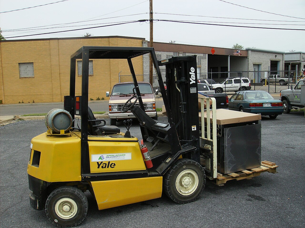 Yale forklift in parking lot of Our Community Place in Harrisonburg, Virginia loaded with kitchen equipment.
