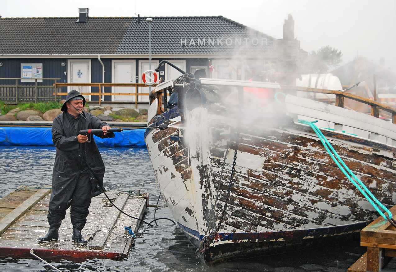 Pressure washer used to remove old paint from a boat.